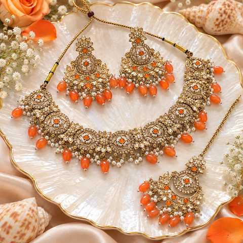Beautiful polki stones with pearls and colorful stones necklace & earrings with Tikka. Slight variations in colour and design are possible