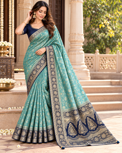 Dola Silk Saree with elegant all-over floral zari weaving and a rich contrasting woven border with detailed pallu. Soft, graceful drape with a luxurious festive look. Contrast blouse piece included.Slight variation in colour and design is possible.
