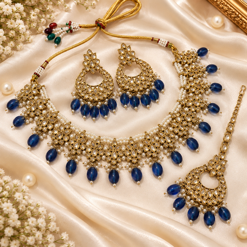 Beautiful polki stones with pearls and colorful stones necklace & earrings with Tikka. Slight variations in colour and design are possible.