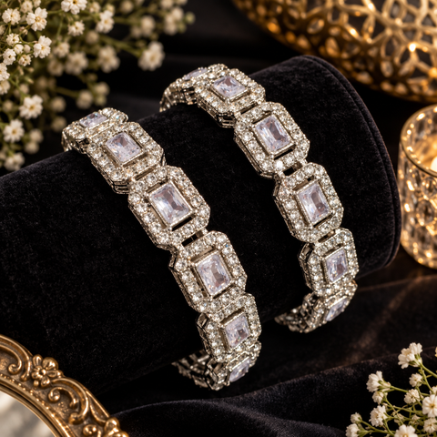 Silver-Tone Stone Bangles.Beautifully set with large clear stones and sparkling accents, these bangles add an elegant touch to festive and party looks.One set includes 2 bangles. Price is per set(Slight variations in color & design is possible )
