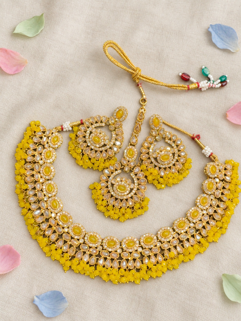 Beautifully crafted with sparkling golden stones, Polki-look stones, and colourful beads. Slight variations in colour and design are possible.