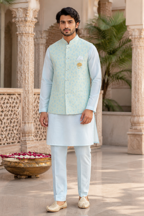 Elegant Ice Blue Kurta Set with Designer Floral Jacket – A premium ice blue kurta set paired with a sophisticated floral woven Nehru jacket, perfect for weddings and festive celebrations. Slight variation in color and design may occur.