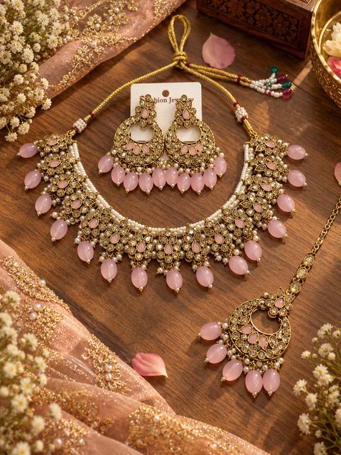Beautiful polki stones with pearls and colorful stones necklace & earrings with Tikka. Slight variations in colour and design are possible.