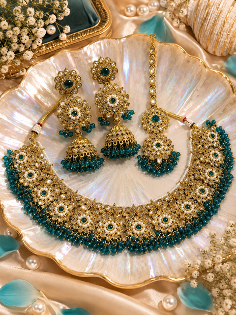 Beautifully crafted with sparkling golden stones, Polki-look stones, and colourful beads. Slight variations in colour and design are possible.