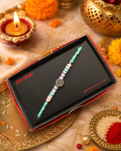 Beautiful Small Om Rakhi featuring a spiritual centrepiece, Rudraksha beads and elegant gold accents. A meaningful choice to celebrate Raksha Bandhan with blessings, love and tradition.