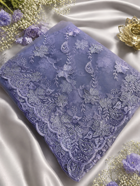 Lavender color Net Saree Adorned With Intricate Embroidery, stonework  Detailing & Beautiful Border. The Blouse Worn By The Model Is For Reference Purposes Only. The Actual Blouse Piece Comes Attached With Saree(Slight Variations Are Possible)