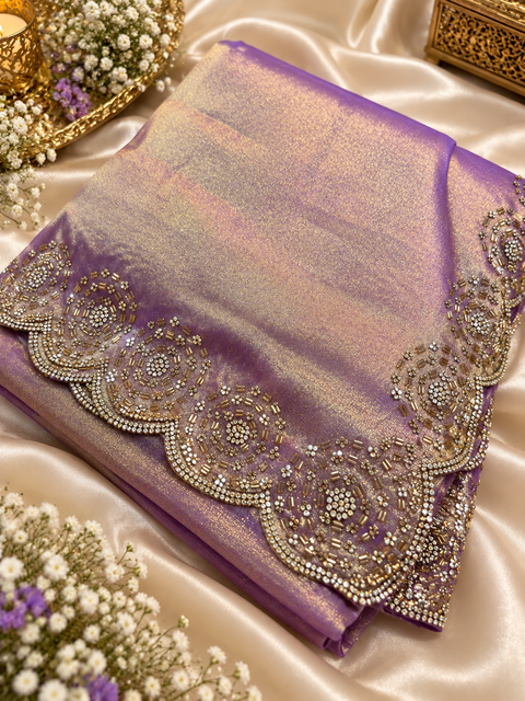 Two-Tone Tissue Silk Saree with a beautiful gold sheen and elegant handcrafted border detailing. Comes with an attached blouse piece; blouse worn by the model is for reference only. Slight variation in colour and design is possible.