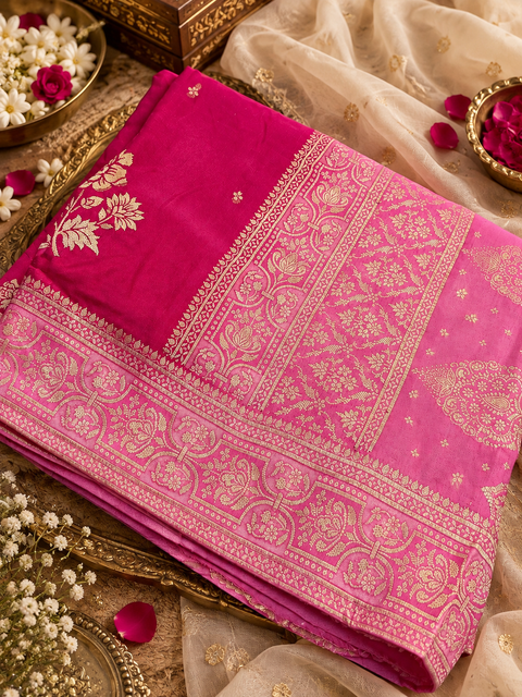 Dola Silk Saree with elegant all-over floral zari weaving and a rich contrasting woven border with detailed pallu. Soft, graceful drape with a luxurious festive look. Contrast blouse piece included.Slight variation in colour and design is possible.