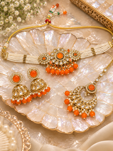 Beautiful Kundan stones with pearls and colorful stones choker necklace & Jhumka with Tikka. Slight variations in colour and design are possible.