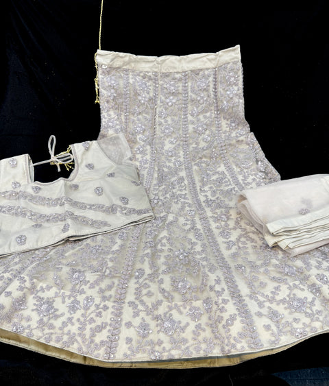 Dusty grey colour netting based embroidery with stone work all over on lehnga & blouse with netting embroidered dupatta