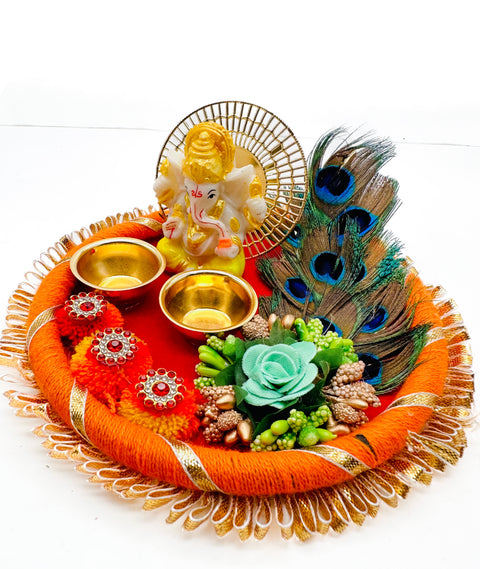 Beautiful Ganesha Murti decorated in plate with peacock feather and Jyoti stand attached