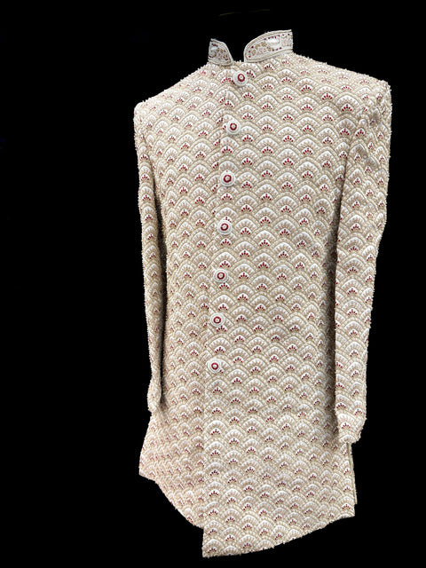 (Video clip attached )Cream based maroon color heavy embroidery & pearl sequined work all over with hand work pearl beaded neck, buttons and sleeves design Sherwani and Pants
