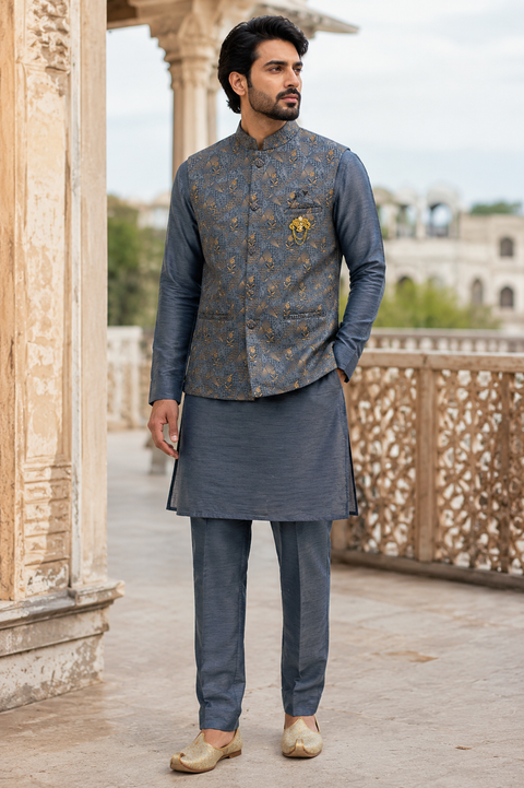 Elegant Slate Grey Kurta Set with Designer Woven Jacket – sophisticated slate grey kurta paired with a premium woven Nehru jacket featuring intricate gold detailing, perfect for weddings and festive occasionsSlight variation in color and design may occur