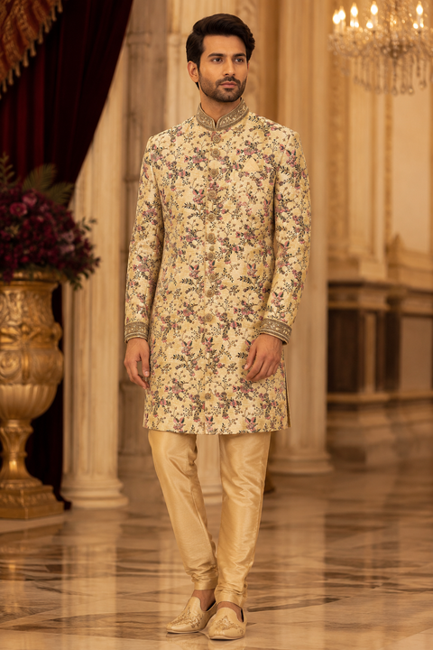 Premium ivory floral printed sherwani with intricate embroidered collar and cuff detailing, crafted for a sophisticated and elegant wedding celebration look. Slight variation in color and design may occur