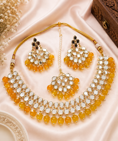 Elegant mirror necklace set adorned with beads and pearl detailing, perfect for adding a royal touch to your traditional look
 ( slight variation in color and design is possible )