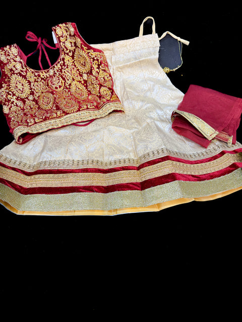 Dark Maroon colour velvet based blouse with embroidery & Stone work with golden brocade silk Lehnga & netting dupatta