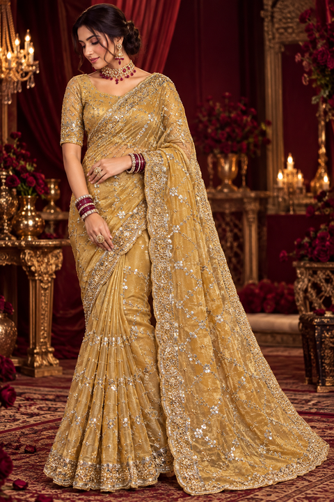 Elegant Dark Gold  Partywear Saree featuring all-over sequin and beadwork with a beautifully detailed heavy scalloped border for a rich festive look. Comes with an attached blouse piece. Slight variation in colour and design is possible.