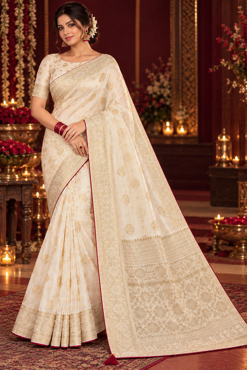 Luxuriously soft silk saree with a smooth, lightweight feel and beautifully flowy drape. Featuring rich woven zari floral motifs and an elegant detailed border .Blouse piece included. Slight variation in colour and design is possible.