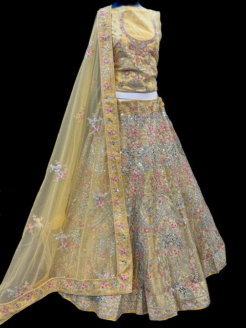 (Video clip attached)Gold colour netting Based Beautiful Embroidery & Mirror Work With Golden Fine Stones& beaded work Very Heavy Layered Designer semi/Bridal Lehnga With Heavy Tessels Attached To Blouse & Lehnga