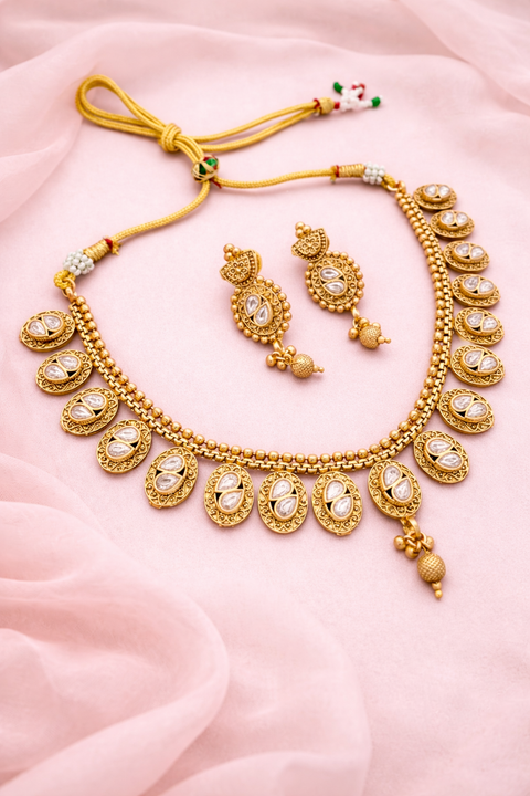 Elegant golden color necklace set with kundan stones and pearl drop, perfect for weddings and festive wear