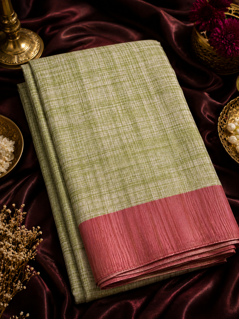 Soft linen-blend saree with a beautiful textured finish and contrast border, offering a graceful blend of comfort and timeless style,Comes with an unstitched running blouse piece attached to the saree (slight variation in color and design is possible