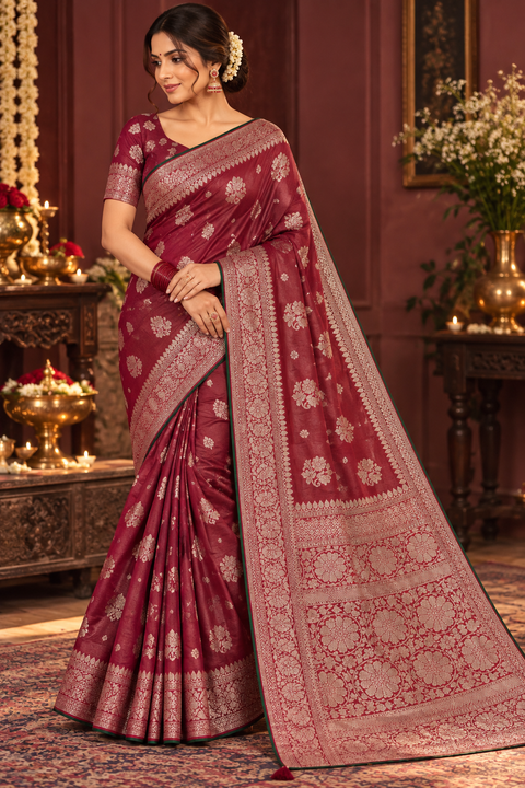 Luxuriously soft silk saree with a smooth, lightweight feel and beautifully flowy drape. Featuring rich woven zari floral motifs and an elegant detailed border .Blouse piece included. Slight variation in colour and design is possible.