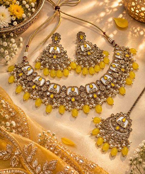 Beautiful polki stones with pearls and colorful stones necklace & earrings with Tikka. Slight variations in colour and design are possible