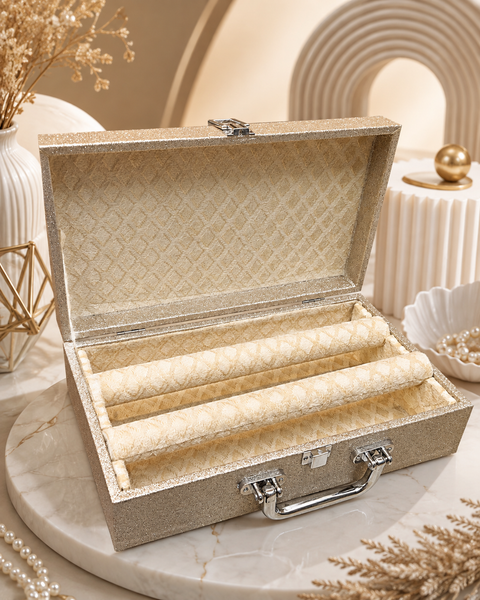 Beautiful champagne-gold bangle box with a sparkling finish, elegant patterned interior, and two spacious bangle holders. A stylish and practical way to store and organise your bangles safely.