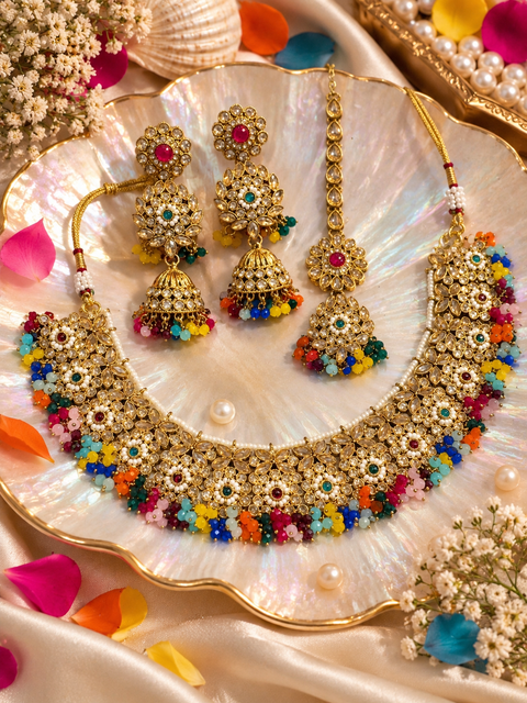 Beautifully crafted with sparkling golden stones, Polki-look stones, and colourful beads. Slight variations in colour and design are possible.