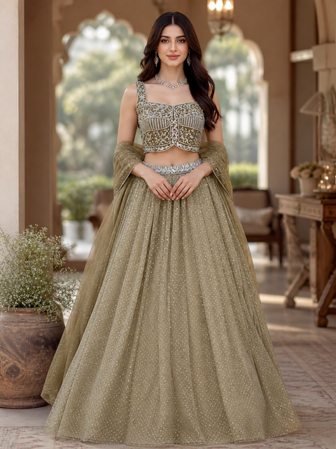 Netting based stones with mirror work designer blouse with shimmery netting heavy flared lehnga and netting based sequined work dupatta