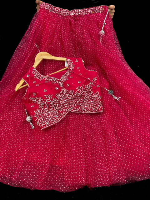 Netting based stones with mirror work designer blouse with shimmery netting heavy flared lehnga and netting based sequined work dupatta