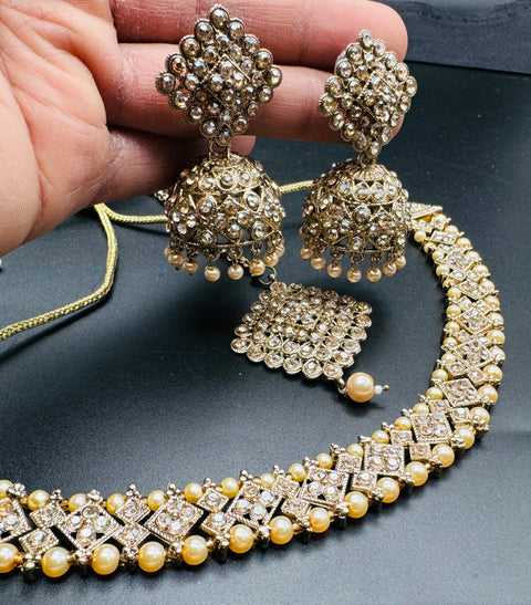 Golden color Beautiful jerkan stone with pearls beaded necklace with jhumka and tikka set