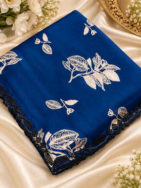 Fendi Silk Saree – Elegant floral print with beautiful black stone handwork border all around. Soft, stylish, two toned shiny. Matching blouse piece attached; model blouse is for reference only. Slight variation in colour/design is possible.