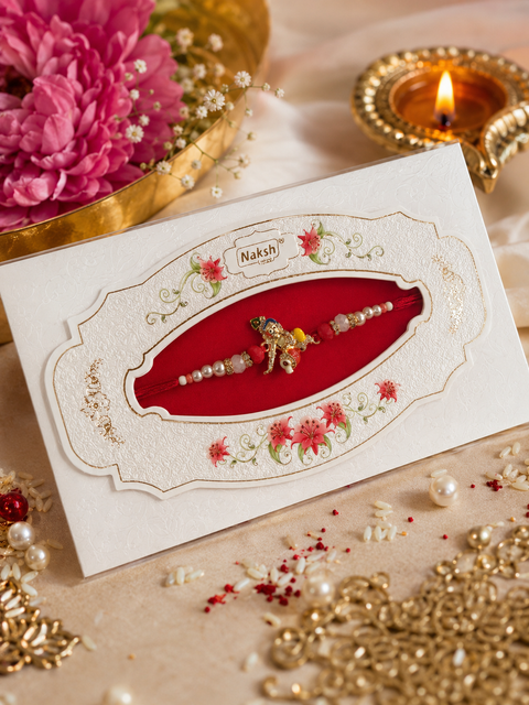 American Diamond Stylish stone designer Rakhi with pearl detailing, presented in a premium gift box
