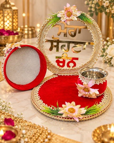 Elegant Punjabi Karwa Chauth Thali Set with red velvet, gold detailing, pearl work and floral accents. Includes matching thali, channi and bowl.Slight variation in colour and design is possible.