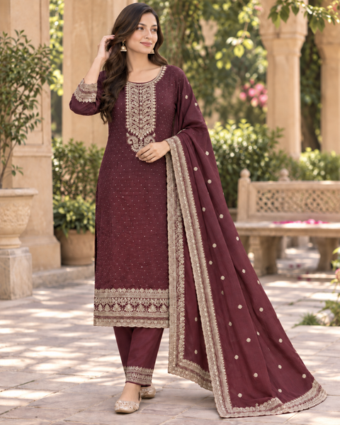 Dusty Wine set featuring elegant golden embroidery on the neckline, sleeves and hem, paired with matching pants and a beautifully bordered dupatta.Slight variation in colour and design may be possible.