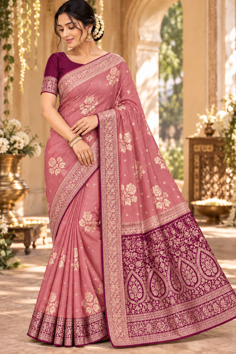 Dola Silk Saree with elegant all-over floral zari weaving and a rich contrasting woven border with detailed pallu. Soft, graceful drape with a luxurious festive look. Contrast blouse piece included.Slight variation in colour and design is possible.