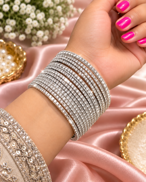 Silver stone bangles with sparkling crystal work and an elegant finish. Set of 8 bangles. Price is per set. Slight variation in colour and design may be possible.