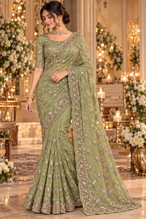 Fendi Silk Saree featuring all-over intricate handwork,sequin detailing and a heavily embellished scalloped border for a rich festive look. Attached blouse piece included; model blouse is for reference only. Slight variation in colour and design may occur
