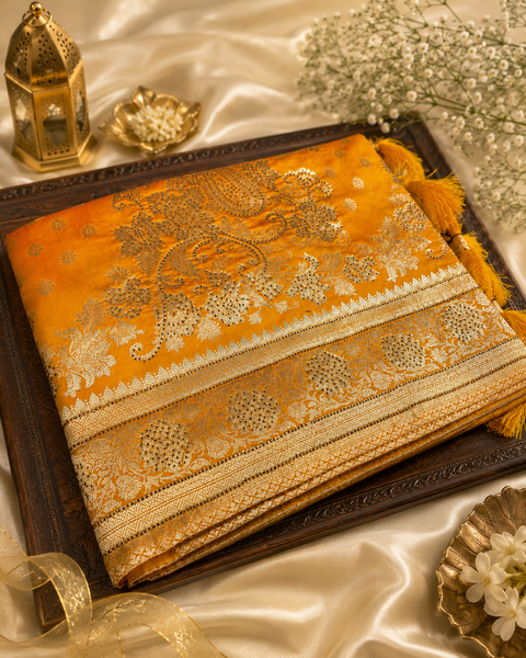 Banarasi Silk Saree Featuring Elegant Zari Weaving & stone work with tessels on Pallu Saree Comes With An Attached Blouse Piece. Model Blouse Is For Reference Only. Slight Variation In Colour And Design May Occur