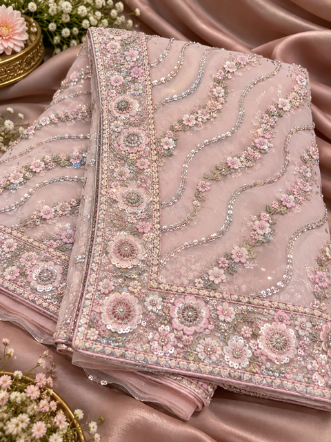 Heavy Embroidered Net Saree Beautiful net saree with all-over floral embroidery, sequin work & a rich heavy border.Blouse shown is for reference only; actual blouse piece is attached with the saree. Slight variation in colour/design possible.