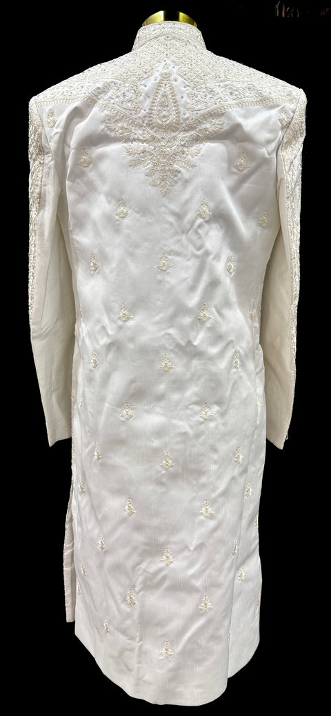 (Video clip attached )Cream color heavy embroidery work all over with hand work pearl beaded neck, buttons and sleeves design Sherwani and Pants