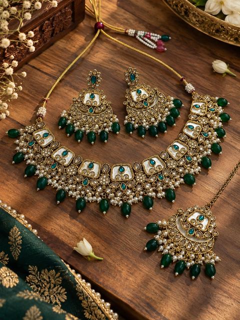Beautiful polki stones with pearls and colorful stones necklace & earrings with Tikka. Slight variations in colour and design are possible