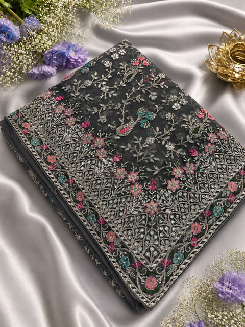 Dark Grey color designer Saree with netting base fabric and stones work design all over with heavy embroidery.The Blouse Worn By The Model Is For Reference Purposes Only. The Actual Blouse Piece Comes Attached With Saree(Slight Variations Are Possible)