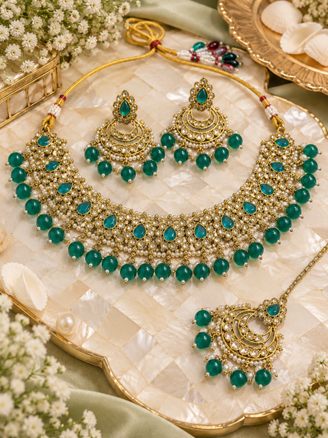 Beautiful polki stones with pearls and colorful stones necklace & earrings with Tikka. Slight variations in colour and design are possible
