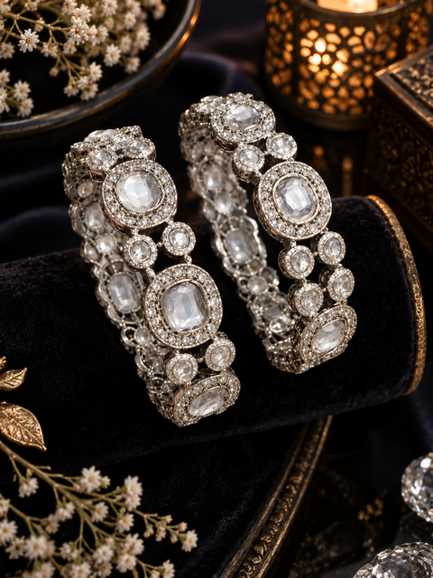 Silver-Tone Stone Bangles.Beautifully set with large clear stones and sparkling accents, these bangles add an elegant touch to festive and party looks.One set includes 2 bangles. Price is per set(Slight variations in color & design is possible )
