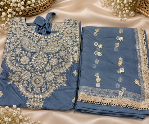 Elegant Chanderi Silk suit featuring all-over heavy embroidery and mirror work with a beautifully detailed neckline. Paired with a heavily embroidered palazzo and a gorgeous matching dupatta .Slight variation may ofcolour & design is possible