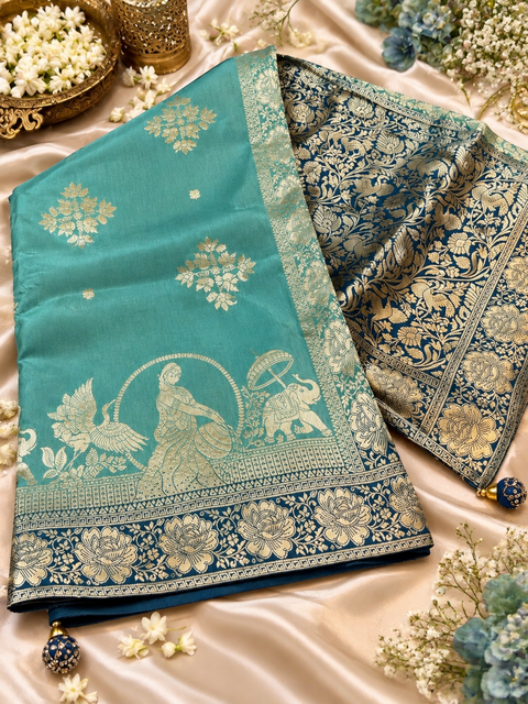 Dola Silk Saree with elegant all-over floral zari weaving and a rich contrasting woven border with detailed pallu. model blouse for reference only.Contrast blouse piece included.Slight variation in colour and design is possible.