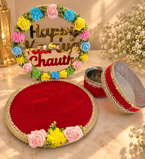 Elegant Karwa Chauth Thali Set in a vibrant red and gold theme, beautifully enhanced with floral accents and a decorative “Happy Karwa Chauth” backdrop. This coordinated set includes a matching thali, channi, kalash and festive stand, making it a perfect
