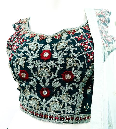 Embroidery with Mirror work silk based designer blouse with heavy flared printed  ken ken lehnga with tessels attached and netting dupatta with lace border and tessels